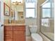 Clean bathroom with granite countertop, shower/tub combo, and wood cabinets at 4111 Hemingway Dr, Venice, FL 34293