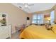 Bedroom with yellow bedding, dresser, and ensuite bathroom access at 4111 Hemingway Dr, Venice, FL 34293
