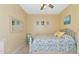Bright bedroom with floral bedding and a ceiling fan at 4111 Hemingway Dr, Venice, FL 34293