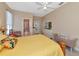 Main bedroom with ensuite bathroom and a yellow quilt on the bed at 4111 Hemingway Dr, Venice, FL 34293