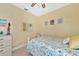 Bright bedroom with floral bedding and a ceiling fan at 4111 Hemingway Dr, Venice, FL 34293