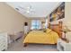 Main bedroom with yellow bedding and a tropical-themed wall art at 4111 Hemingway Dr, Venice, FL 34293