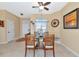 Dining room with glass table, wicker chairs, and ceiling fan at 4111 Hemingway Dr, Venice, FL 34293