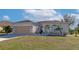 One-story home with attached garage and landscaped yard at 4111 Hemingway Dr, Venice, FL 34293