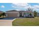 One-story home with attached garage and landscaped yard at 4111 Hemingway Dr, Venice, FL 34293