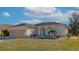 One-story home with attached garage and landscaped yard at 4111 Hemingway Dr, Venice, FL 34293