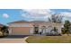 Single-story home with attached garage, landscaping, and a well-maintained lawn at 4111 Hemingway Dr, Venice, FL 34293