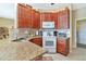 Well-equipped kitchen with granite countertops and wood cabinets at 4111 Hemingway Dr, Venice, FL 34293