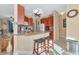 Kitchen features wood cabinets, granite counters, and breakfast bar at 4111 Hemingway Dr, Venice, FL 34293