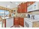 Well-equipped kitchen with granite countertops and wood cabinets at 4111 Hemingway Dr, Venice, FL 34293