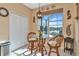 Kitchen nook with glass table, wicker chairs, and view of lake at 4111 Hemingway Dr, Venice, FL 34293