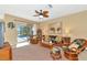Spacious living room boasts wicker furniture and access to a relaxing pool area at 4111 Hemingway Dr, Venice, FL 34293