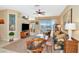 Bright living room with wicker furniture, water view, and sliding glass doors at 4111 Hemingway Dr, Venice, FL 34293