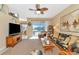 Living room features wicker furniture, a large TV, and serene water views at 4111 Hemingway Dr, Venice, FL 34293