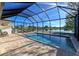 Inviting screened-in pool and patio overlooking a tranquil lake at 4111 Hemingway Dr, Venice, FL 34293
