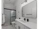 Modern bathroom with white vanity, mirror, and shower at 4214 Palacio Dr, Sarasota, FL 34238