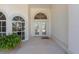 Front entry with double doors, arched windows, and a potted plant at 4214 Palacio Dr, Sarasota, FL 34238
