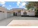 Three-car garage and entrance to a light-colored house at 4214 Palacio Dr, Sarasota, FL 34238