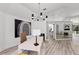 Bright home office features a large desk, modern chandelier, and stylish artwork at 4214 Palacio Dr, Sarasota, FL 34238