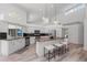 Modern kitchen features granite island, stainless steel appliances, and white cabinetry at 4214 Palacio Dr, Sarasota, FL 34238