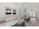 Spacious living room with light flooring, white sofa, and large windows at 4214 Palacio Dr, Sarasota, FL 34238