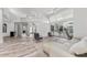 Living area with light wood floors, white sofa, and access to the pool area at 4214 Palacio Dr, Sarasota, FL 34238