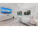 Bright bedroom with large TV, sliding glass doors to pool area, and light flooring at 4214 Palacio Dr, Sarasota, FL 34238