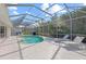 Large screened pool and patio area with lounge chairs at 4214 Palacio Dr, Sarasota, FL 34238