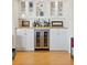 Elegant bar area with a wine fridge and glass-front cabinets at 435 S Gulfstream Ave # 604, Sarasota, FL 34236
