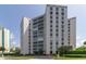 Beautiful condo building with lush landscaping and circular driveway at 435 S Gulfstream Ave # 604, Sarasota, FL 34236