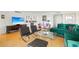 Living room with hardwood floors, green sectional sofa, and flat-screen TV at 435 S Gulfstream Ave # 604, Sarasota, FL 34236