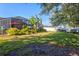 Landscaped backyard with screened patio and grassy lawn at 4440 Sanibel Way, Bradenton, FL 34203