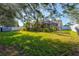 Large backyard with lush landscaping and mature trees at 4440 Sanibel Way, Bradenton, FL 34203