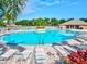 Community pool with surrounding lounge chairs at 4440 Sanibel Way, Bradenton, FL 34203