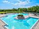 Community pool with lounge chairs and landscaping at 4440 Sanibel Way, Bradenton, FL 34203