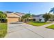 Attractive tan house with a large driveway and lush landscaping at 4440 Sanibel Way, Bradenton, FL 34203