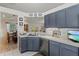 Galley style kitchen with stainless steel appliances and blue cabinets at 4440 Sanibel Way, Bradenton, FL 34203
