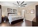 King-size bed, dark wood furniture, and laminate wood floors in this main bedroom at 4440 Sanibel Way, Bradenton, FL 34203