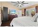 Main bedroom with large TV, sliding doors to the pool, and a walk-in closet at 4440 Sanibel Way, Bradenton, FL 34203