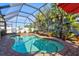 Lush landscaping surrounds this screened pool and spa at 4440 Sanibel Way, Bradenton, FL 34203