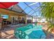 Covered patio with pool, spa, and outdoor kitchen at 4440 Sanibel Way, Bradenton, FL 34203