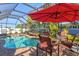 Relaxing screened pool and spa with patio furniture, creating an inviting outdoor oasis at 4440 Sanibel Way, Bradenton, FL 34203