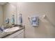 Modern bathroom with granite countertop, white cabinets, and a large mirror at 5282 Grove Mill Loop, Bradenton, FL 34211