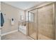 Spa-like bathroom with soaking tub, walk-in shower, and tile flooring at 5282 Grove Mill Loop, Bradenton, FL 34211