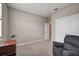 Spacious bedroom with double doors and a comfortable recliner at 5282 Grove Mill Loop, Bradenton, FL 34211