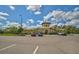 A community clubhouse is showcased with parking, beautiful architecture, and landscaping at 5282 Grove Mill Loop, Bradenton, FL 34211