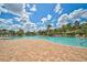 The community pool has ample deck space, seating and is surrounded by palm trees and lush greenery at 5282 Grove Mill Loop, Bradenton, FL 34211