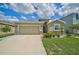 One-story home with a two-car garage and landscaped front yard at 5282 Grove Mill Loop, Bradenton, FL 34211
