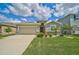 One-story home with a two-car garage and neatly landscaped front yard at 5282 Grove Mill Loop, Bradenton, FL 34211