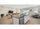 Open kitchen featuring granite island and view into living area at 5282 Grove Mill Loop, Bradenton, FL 34211